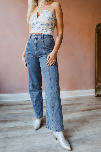 The denim is of a dark wash, featuring a seam detail and two functioning pockets.
