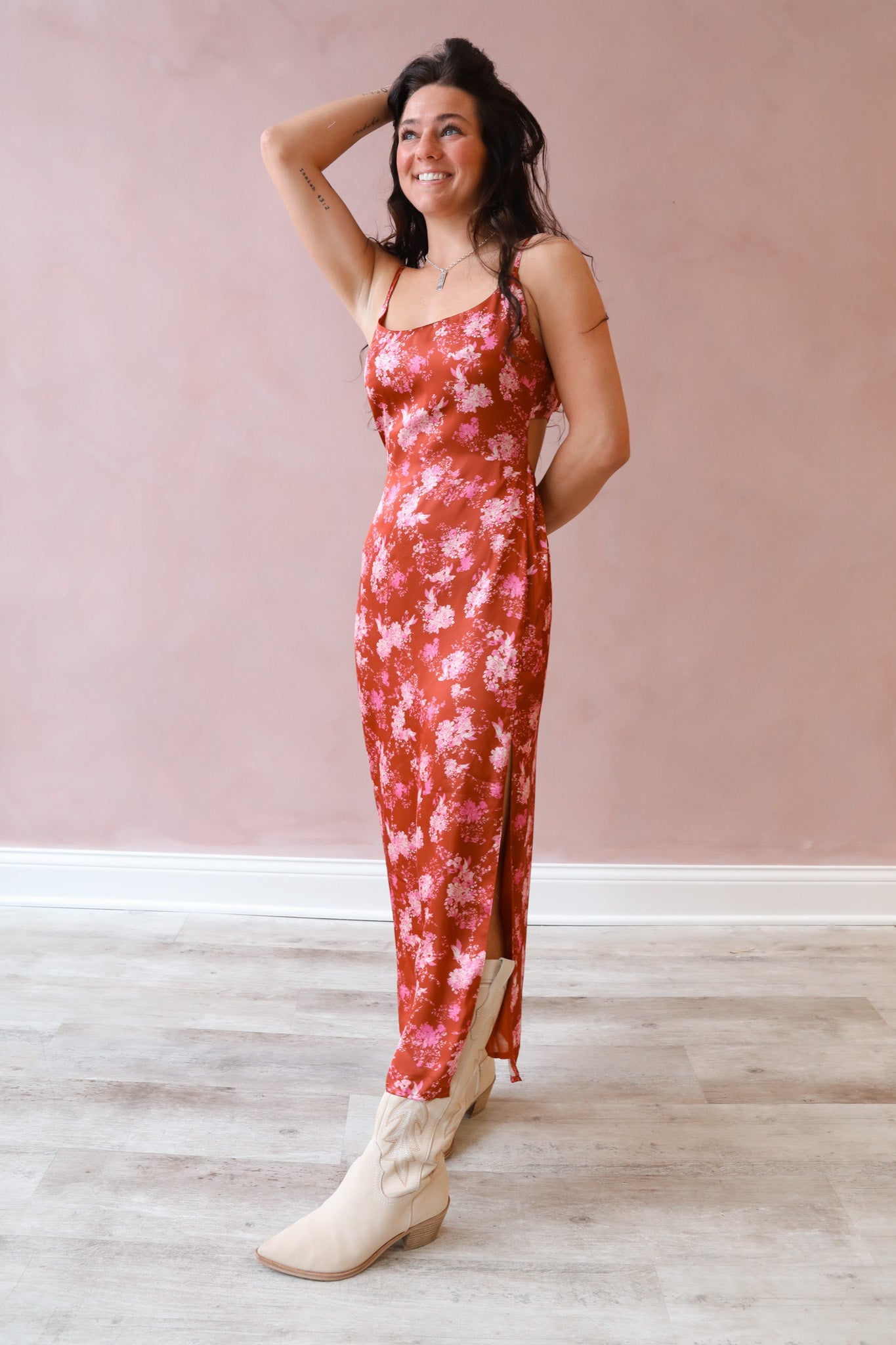 This long satin dress features a rosy pink floral design and a detailed back strap.
