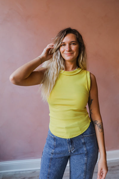 The ideal tank-inspired top, this sleeveless tee is featured in an effortless, goes-with-anything design with rounded bottom hem and exposed seaming for a true lived-in look.