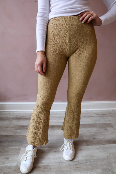The product features taupe-colored popcorn knit fabric and trendy cropped bottoms with bell-shaped hems.