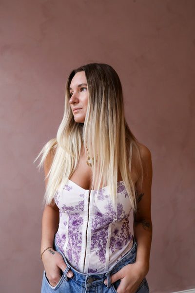 Your favorite corset-inspired bodysuit now featured in a feminine floral print fabrication.